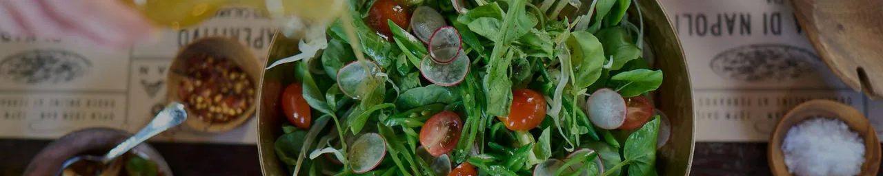 Restaurant table with large salad bowl.