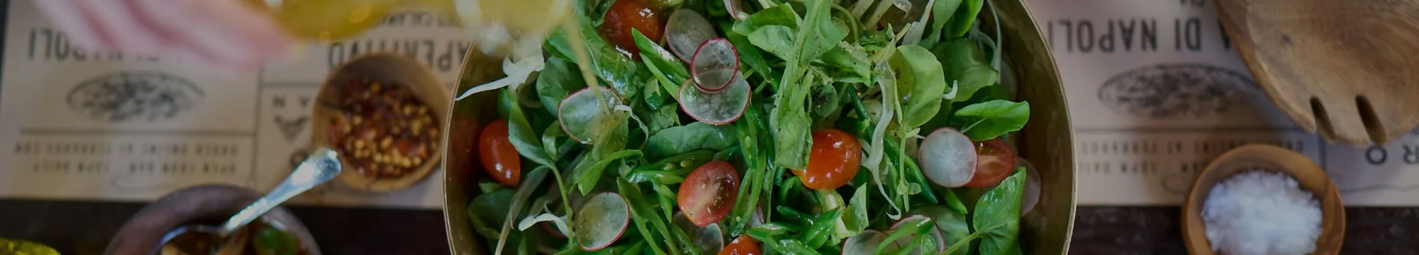 Restaurant table with large salad bowl.