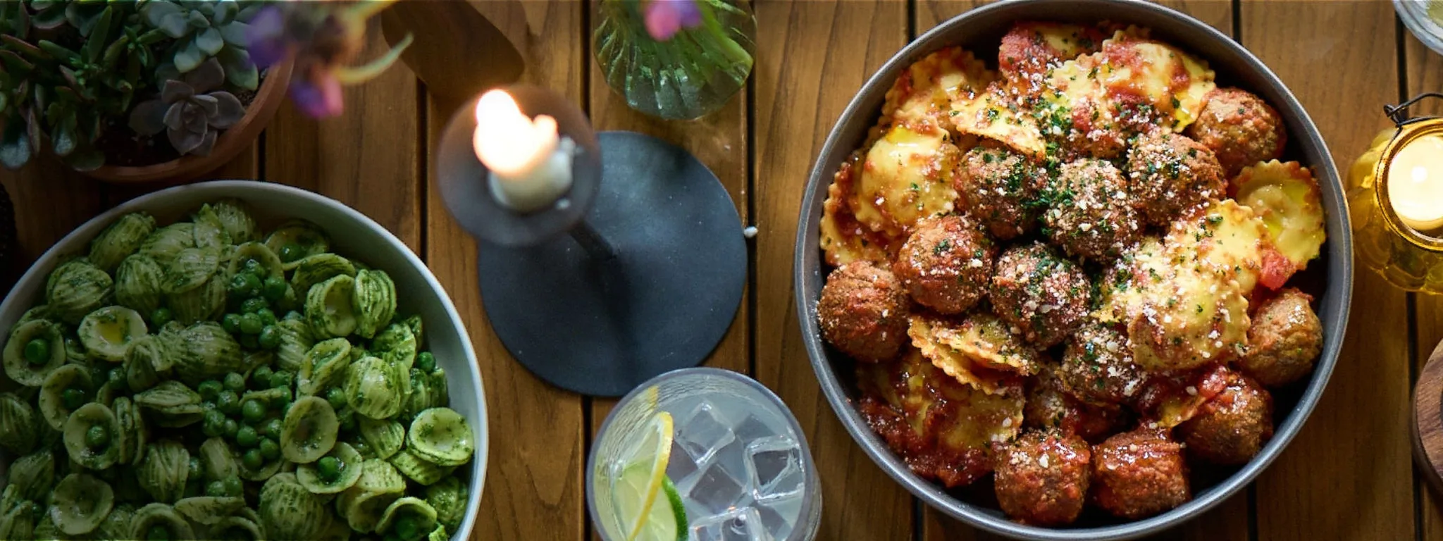 Dinner table scene with bowls of pasta